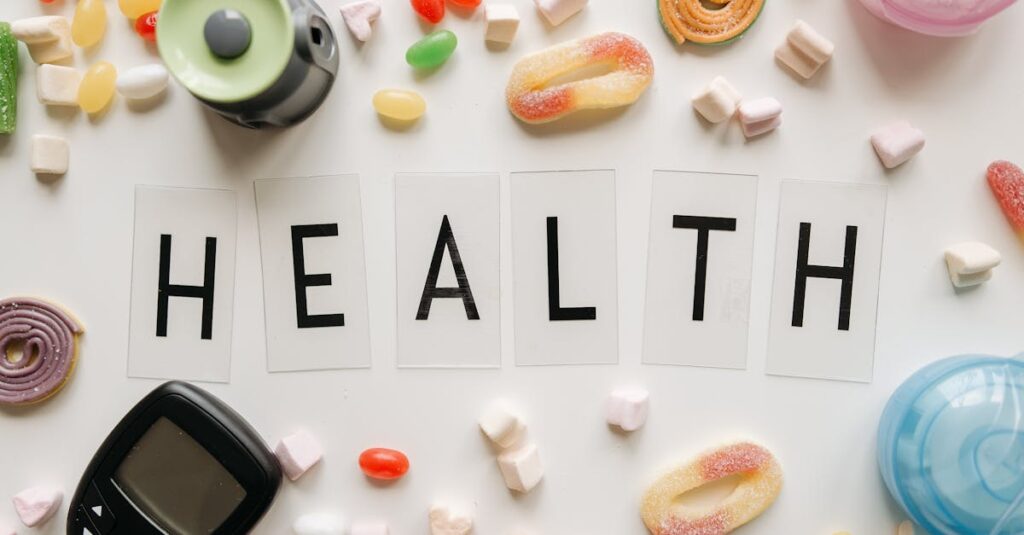 Creative flat lay with sweets around a 'HEALTH' text and monitoring device, symbolizing diabetes awareness.